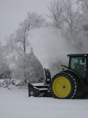 Black Max Heavy Duty Tractor Snow Blower blowing snow.